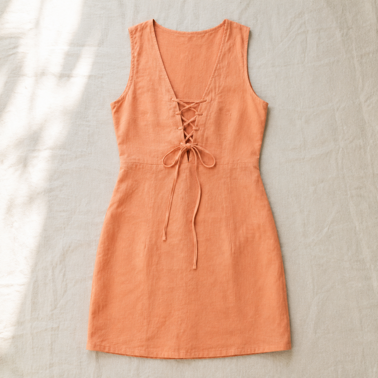 Vivia Linen Tie Dress — Apricot flat lay on cream linen