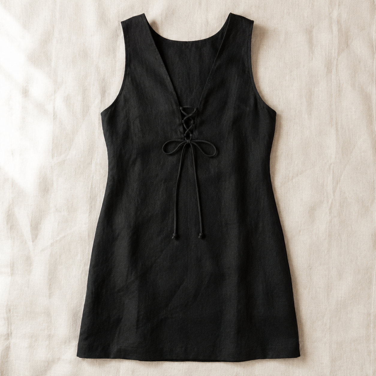 Vivia Linen Tie Dress — Black flat lay on cream linen