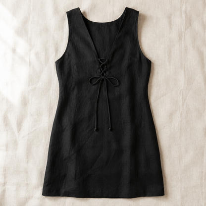 Vivia Linen Tie Dress — Black flat lay on cream linen